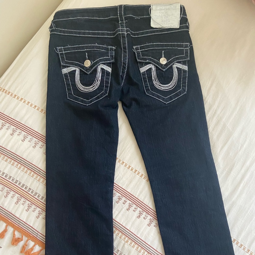 TRUE RELIGION LOW-rise dark denim with white stitching.